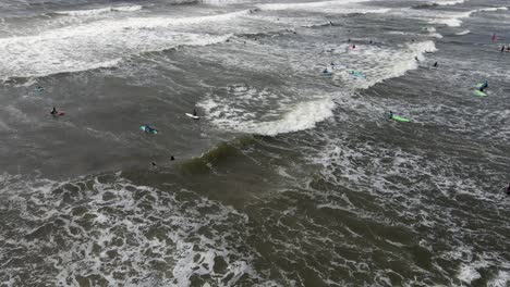 Drone-shot-of-a-lot-of-people-surfing-in-Ireland