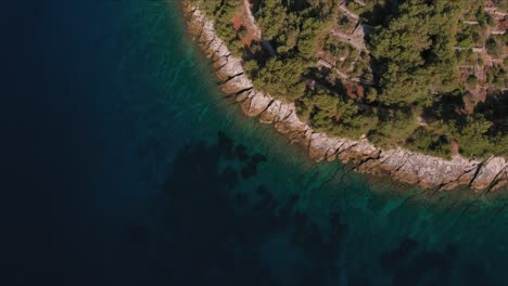 Drone-shot-of-a-small-island-line-with-blue-sea