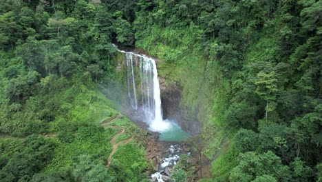 Aerial-truck-left-of-Eco-Chontales-waterfall-falling-down-rocky-natural-pool-surrounded-by-green-dense-rain-woods,-Costa-Rica
