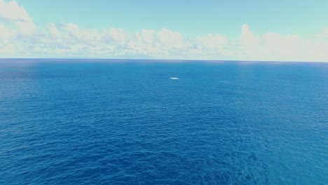 Drohne-Steigt-Auf-Und-Schwenkt-An-Einem-Sonnigen-Tag-über-Den-Tiefblauen-Ozean,-Während-Buckelwale-In-Der-Ferne-Brechen