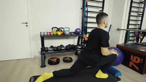Rotating-shot-from-a-man's-face-to-wide-profile-to-show-his-stretching-his-legs-before-a-workout