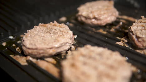 Juicy-Burger-Patties-Cooking-In-A-Grill-Pan-At-Home