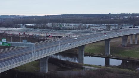 Mersey-gateway-toll-bridge-highway-traffic-driving-across-canal-overpass-aerial-view-orbit-right