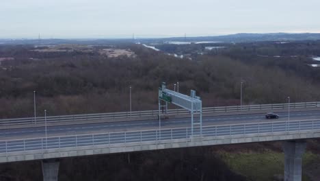 Mersey-gateway-toll-bridge-highway-traffic-driving-across-river-estuary-aerial-view-orbit-right-left