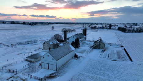 Rural-family-farm-in-winter-snow-at-sunset