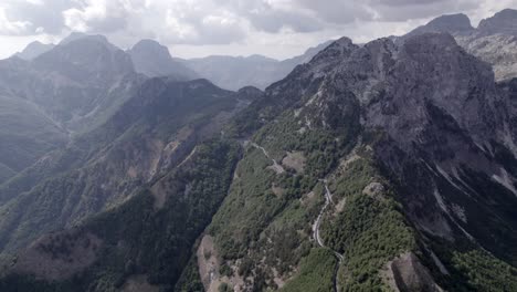 Drone-video-of-"Frontal"-plane,-advancing-on-the-highest-of-the-sh21-the-Theth-mountain-pass-in-albania,-Gjecaj