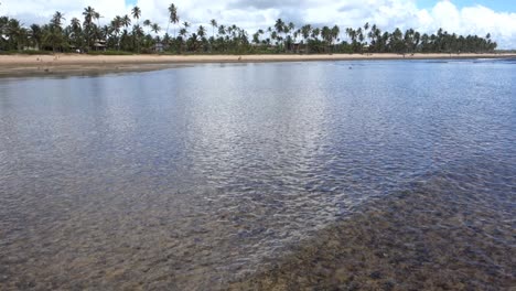 Panoramic-View-Of-Beautiful-Beach-With-Shallow-Clear-Sea-In-Foreground-During-Low-Tide