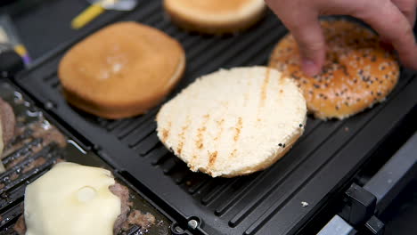 Close-up-of-brioche-bread-bun-over-a-hot-electric-grill-bbq