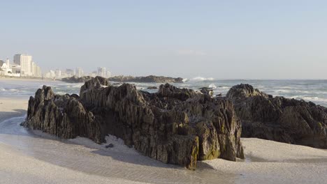 Waves-on-the-Blouberg-Beach-and-view-of-standing-rocks-and-skyscrapers