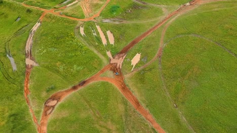 Drone-shot-of-dirtbikes-through-the-mud,-top-down-drone-vies