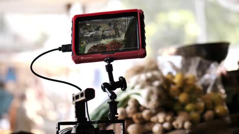 Small-Monitor-On-Clamp-Attached-To-Cage-DSLR-Viewing-Footage-Of-Street-Market