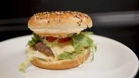 Homemade-Burger-With-Fresh-Lettuce,-Tomato,-And-Cheese-On-The-Table