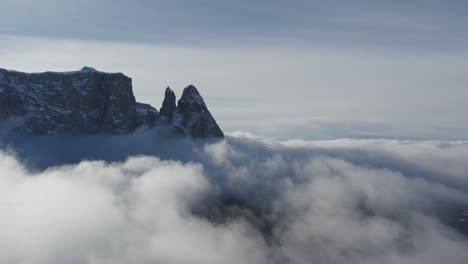 Winte-dolomites-with-drone-over-clouds