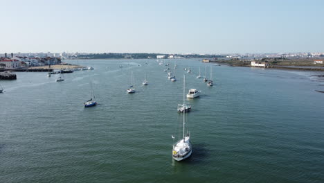 Aerial-View-Of-Boats-Lined-Up-And-Anchored-In-The-Calm-Blue-Sea