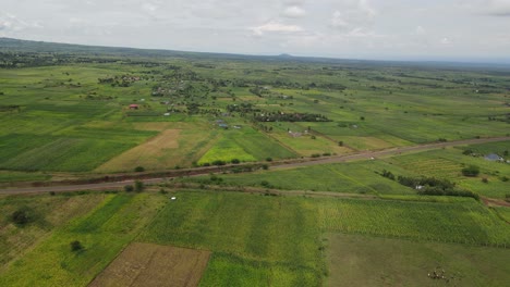Road-amid-plantations-of-rural-area-near-Loitokitok,-Kenya,-aerial-view