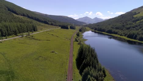 Aerial-push-in-shot-above-Loch-Na-Bi-near-Tyndrum,-Scotland,-on-a-sunny-day