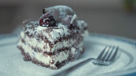 Chocolate-cream-layer-cake-sprinkling-sugar-rotating-plate