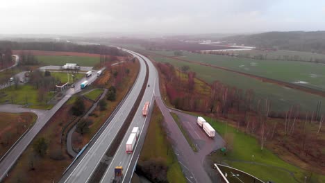 Aerial-drone-footage-of-Rest-Area-North-of-Halmstad,-Sweden-on-European-route-E6-thoroughfare-highway-system-on-cloudy-and-slightly-foggy-day