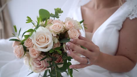 Elegant-bride-white-dress-holding-roses-wedding-bouquet-wearing-diamond-ring,-Slow-motion