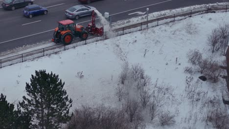 Snow-Blower-Mounted-On-Tractor-Clearing-The-Road-At-Winter-In-Mississauga,-Canada
