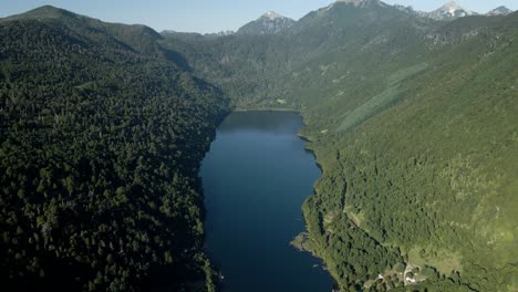 Aerial-dolly-out-of-Tinquilco-lake-between-Andean-mountains-with-green-rain-forest,-Huerquehue-National-Park,-Chile