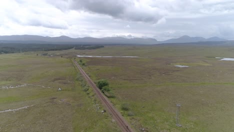 Aerial-push-in-shot-of-Rannoch-Moor-and-the-train-line-that-sits-in-the-landscape