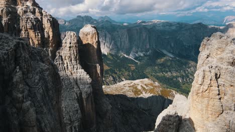 Extremely-steep-mountain-walls-and-peaks-in-the-high-mountains-of-the-Dolomites-in-Italy-with-even-more-mountains-in-the-background