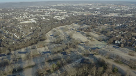 Wide-aerial-drone-view-over-grey-winter-golf-course-in-off-season,-4K