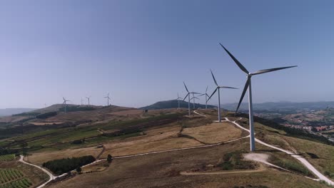 Aerial-view-towards-windmills-turbine-park-on-high-hills,-West-Portugal