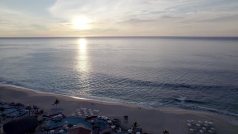 Aerial-panorama-of-beautiful-sunset-over-beach-in-Cabo-San-Lucas,-Mexico