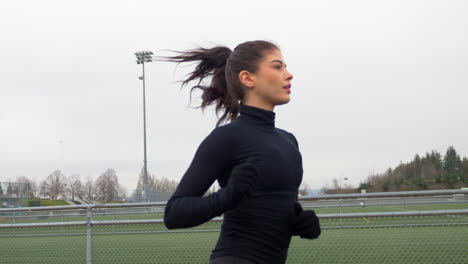 Athletic-Female-Running-Outdoors,-Medium-Tracking-Shot-Slow-Motion
