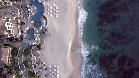 Straight-down-aerial-view-of-a-pristine-tropical-beach-in-a-tropical-resort-and-hotel-destination