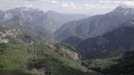 Frontal-drone-video,-moving-over-the-top-of-Theth-Valley-and-Valbona-Valley-in-the-background