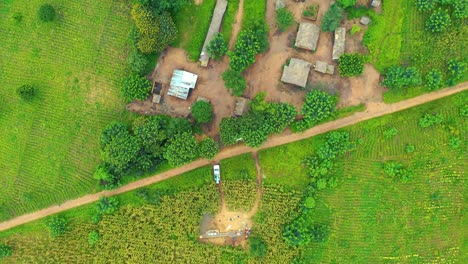 Drone-flying-directly-above-a-remote-village-well-in-Malawi,-Africa