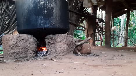 Static-low-POV-shot-of-iron-pot-cooking-on-typical-South-Indian-wood-fired-oven