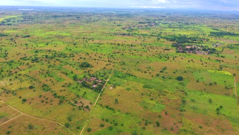 Drone-flying-high-above-villages-in-Malawi,-Africa-during-their-rainy-season