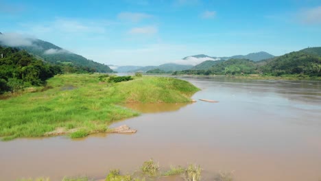 Green-Riverbanks-of-the-Mekong-surrounded-by-Misty-Mountains