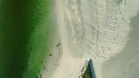 Green-shallow-water-between-the-white-sandy-Seilebost-beach-at-Isle-of-Harris-in-Scotland