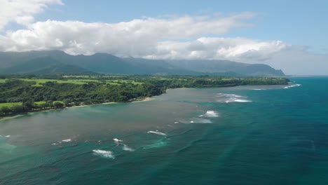 Wide-Aerial-Shot-Tracking-right-away-from-the-coast-at-Anini-Beach,-Kauai,-Hawaii