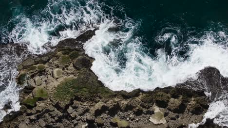Puerto-Rico-ocean-splashing-against-rock-point-from-above-drone-shot