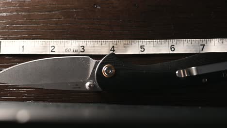 slow-slide-over-a-quality-folding-hunting-knife-with-a-super-smooth-ball-bearing-hinge-as-measured-by-measuring-tape