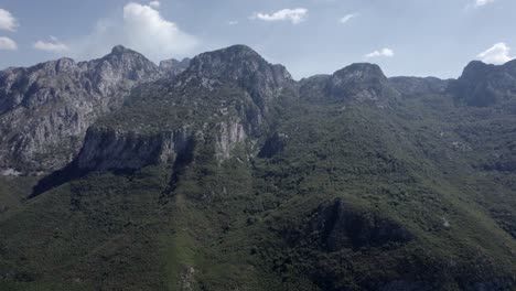 Side-shot-drone-video-"slider"-at-sh21,-albania,-with-the-mountains-in-front-as-the-main-shot