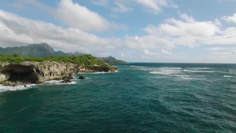 Slow-dramatic-Aerial-Dolly-moving-fast-along-shipwreck-beach,-Hawaii-USA