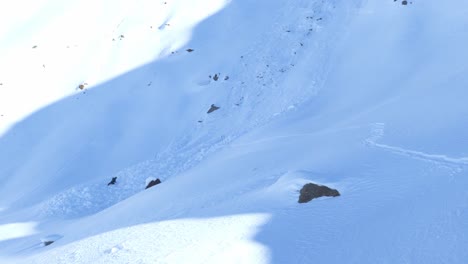 Person-shoveling-for-the-lost-in-a-avalanche-snowslide,-sunny-day-in-the-alps---static-view