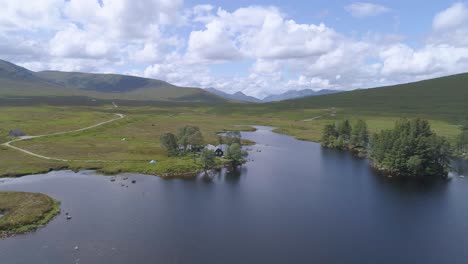 Pull-back-aerial-reveal-shot-over-Loch-Ossian-looking-across-Rannoch-Moor