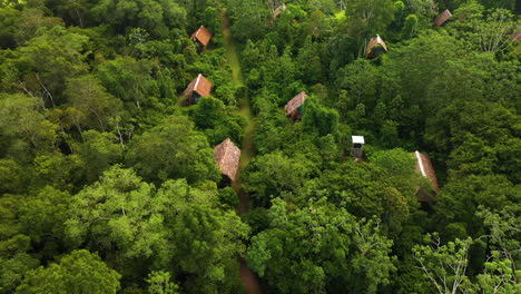 Cinematic-drone-shot-of-jungle-lodges-in-the-Amazon-Rainforest-in-Iquitos-Peru-near-the-Amazon-River