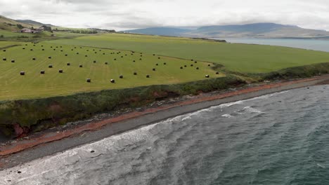 Haystacks-along-the-sea-in-Iceland,-view-from-drone