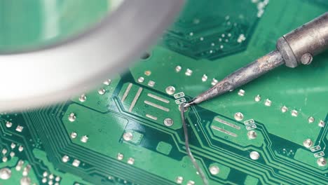 Technician-Soldering-circuit-pin-on-electronic-board,-Computer-repair