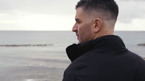 A-man-pensively-looking-out-to-sea-in-slow-motion-with-copy-space
