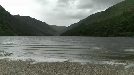 Wilderness-lake-landscape-From-Wicklow-mountains,-Ireland,-Aerial-pullback,-reveal-lake-shore